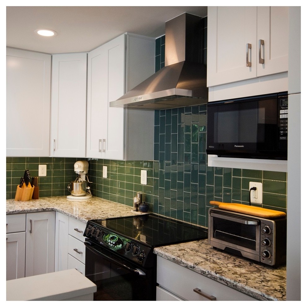 Photo of a medium sized midcentury l-shaped kitchen/diner in Baltimore with a submerged sink, shaker cabinets, white cabinets, engineered stone countertops, green splashback, glass tiled splashback, black appliances, medium hardwood flooring and a breakfast bar.