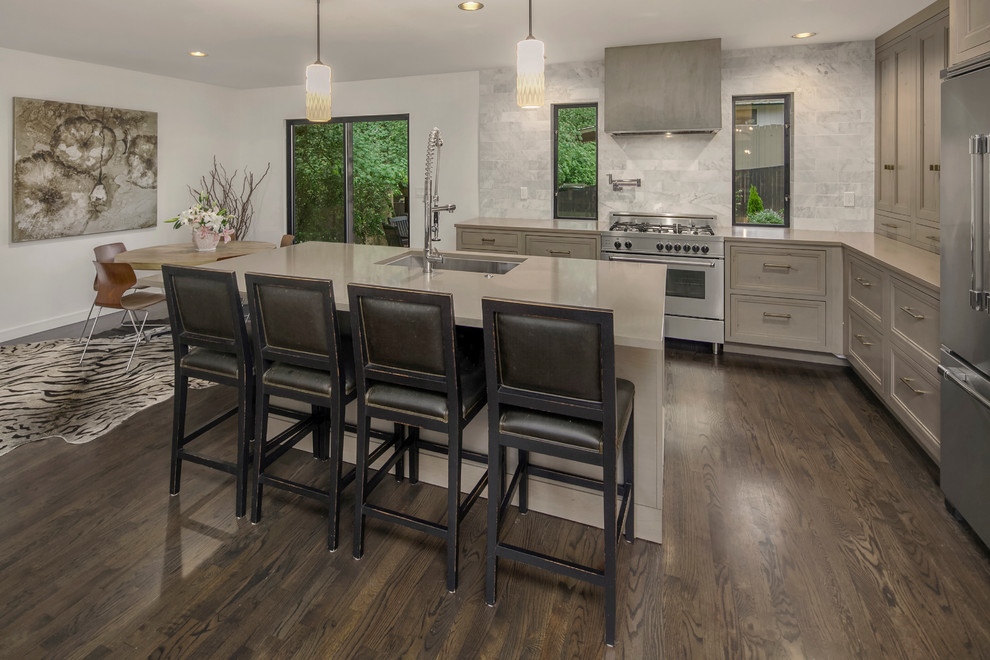 Medium sized l-shaped open plan kitchen in Seattle with a single-bowl sink, beaded cabinets, grey cabinets, engineered stone countertops, white splashback, stone tiled splashback, stainless steel appliances, dark hardwood flooring and an island.
