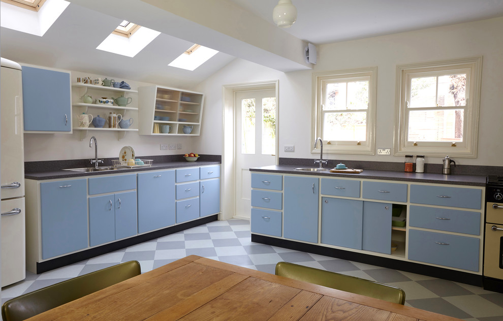 Design ideas for a medium sized midcentury l-shaped kitchen/diner in London with a double-bowl sink, flat-panel cabinets, laminate countertops, grey splashback, integrated appliances, lino flooring, no island, multi-coloured floors and grey worktops.
