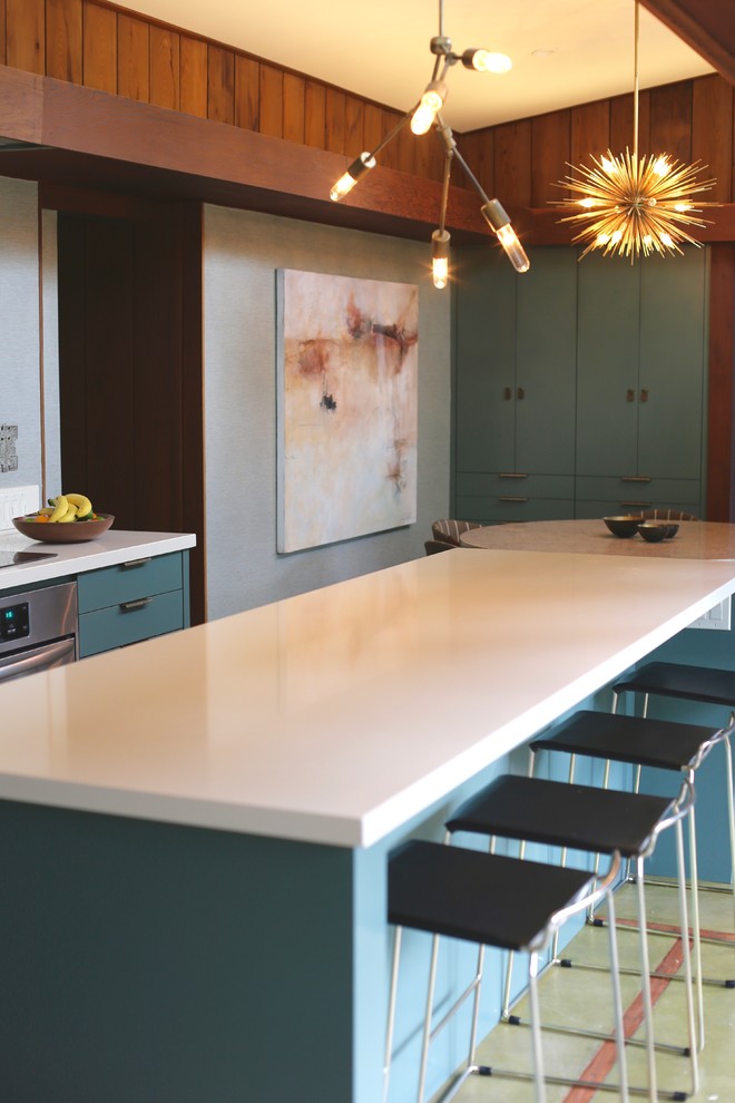 Eat-in kitchen - mid-sized transitional galley concrete floor and green floor eat-in kitchen idea in San Francisco with an integrated sink, flat-panel cabinets, green cabinets, granite countertops, green backsplash and an island