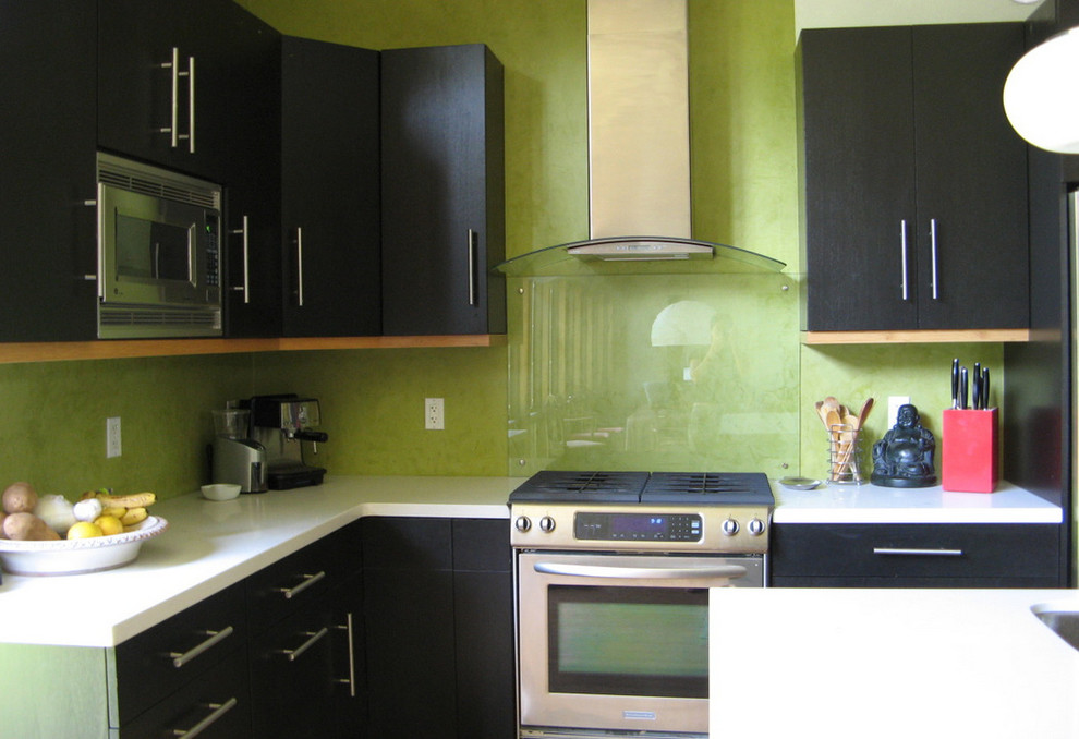 Immagine di una cucina minimalista di medie dimensioni con lavello a doppia vasca, ante lisce, ante in legno bruno, top in quarzo composito, paraspruzzi verde, elettrodomestici in acciaio inossidabile e parquet chiaro