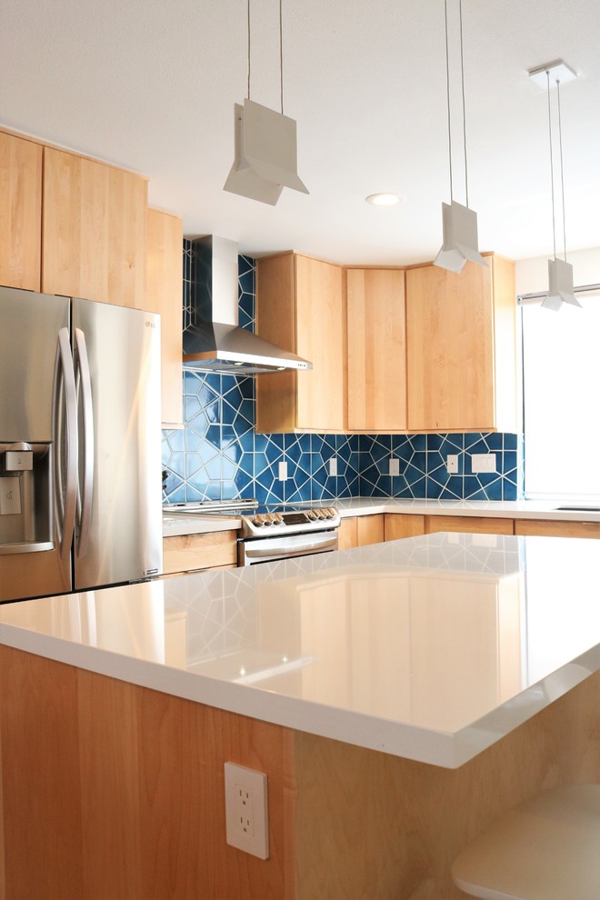 Inspiration for a large mid-century modern l-shaped ceramic tile and gray floor open concept kitchen remodel in Phoenix with an undermount sink, flat-panel cabinets, beige cabinets, quartz countertops, blue backsplash, ceramic backsplash, stainless steel appliances, an island and white countertops