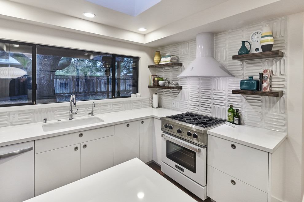 Large 1960s u-shaped dark wood floor and brown floor open concept kitchen photo in San Francisco with an undermount sink, flat-panel cabinets, white cabinets, quartzite countertops, white backsplash, white appliances and an island
