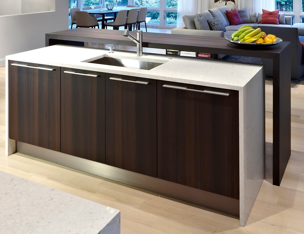 Example of a minimalist u-shaped eat-in kitchen design in DC Metro with an integrated sink, flat-panel cabinets, dark wood cabinets, quartz countertops, white backsplash, stone slab backsplash and stainless steel appliances