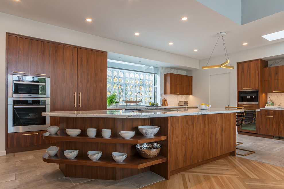 Large retro l-shaped kitchen/diner in San Diego with a submerged sink, flat-panel cabinets, brown cabinets, marble worktops, white splashback, stone slab splashback, integrated appliances, porcelain flooring and an island.