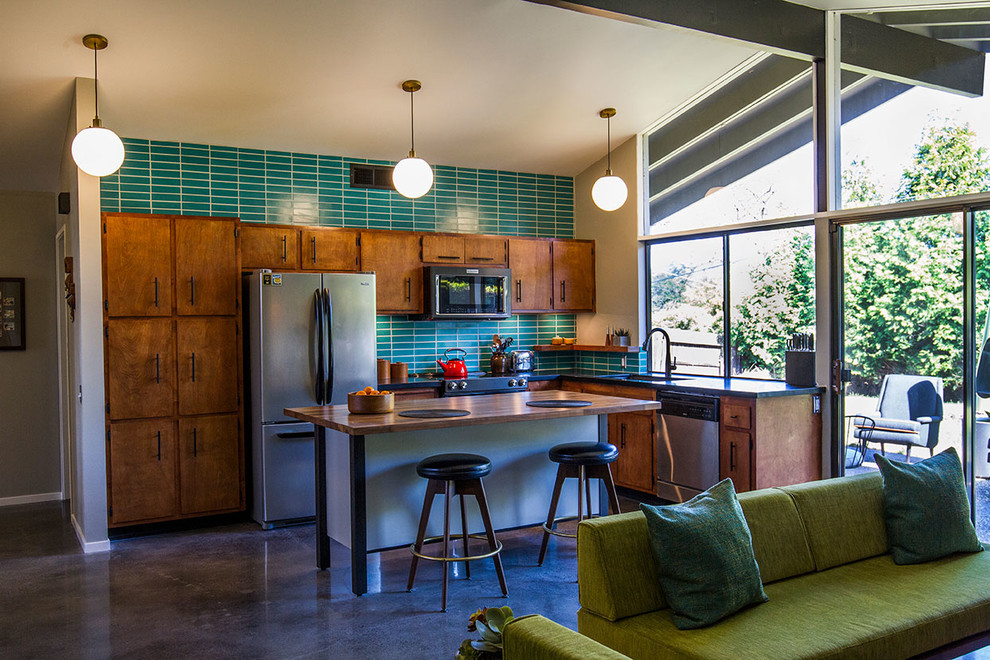 Kitchen - mid-century modern kitchen idea in Sacramento with dark wood cabinets, green backsplash, ceramic backsplash and an island
