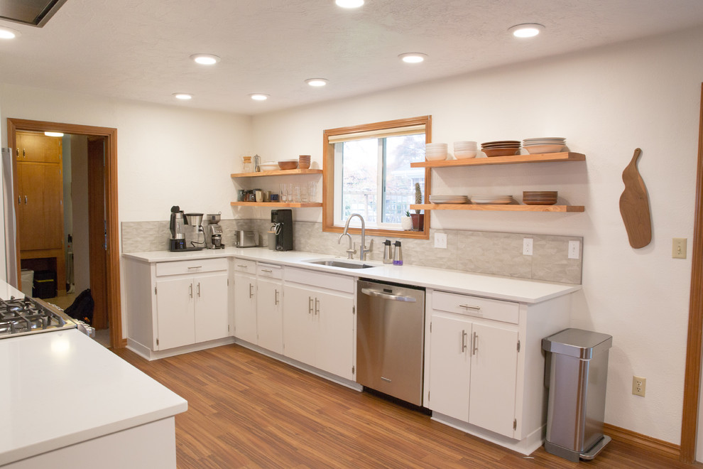Mid-sized 1950s galley vinyl floor open concept kitchen photo in Other with an undermount sink, flat-panel cabinets, white cabinets, quartzite countertops, gray backsplash, porcelain backsplash, stainless steel appliances and a peninsula