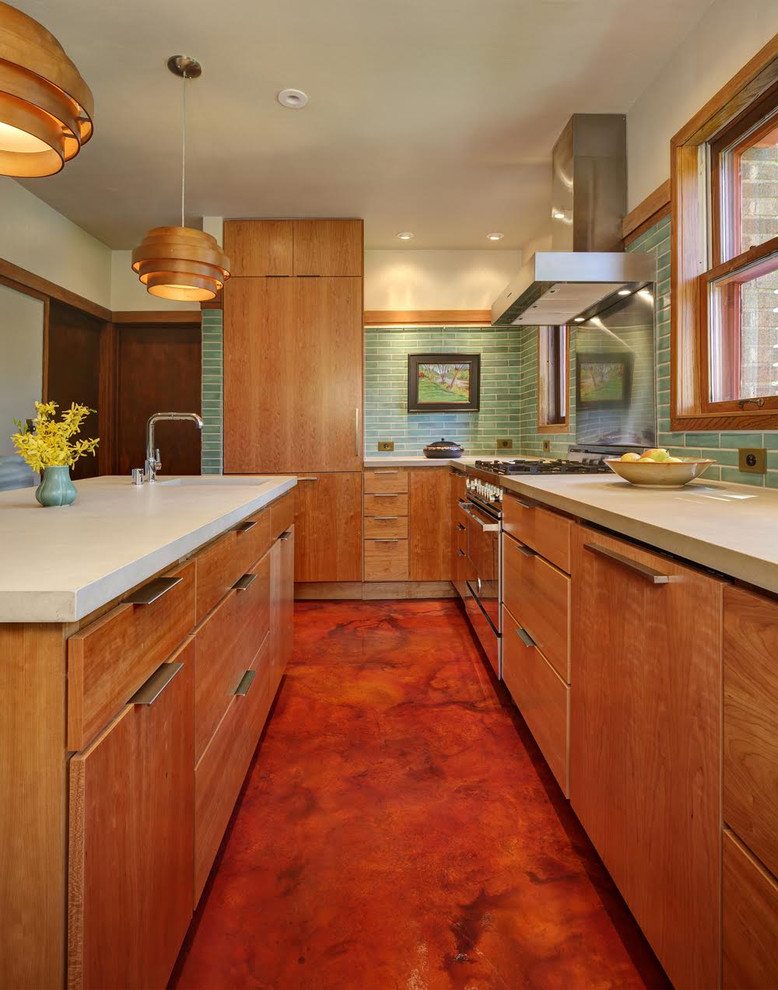 Inspiration for a mid-sized mid-century modern l-shaped eat-in kitchen remodel in Milwaukee with a farmhouse sink, flat-panel cabinets, medium tone wood cabinets, green backsplash, ceramic backsplash, stainless steel appliances and an island