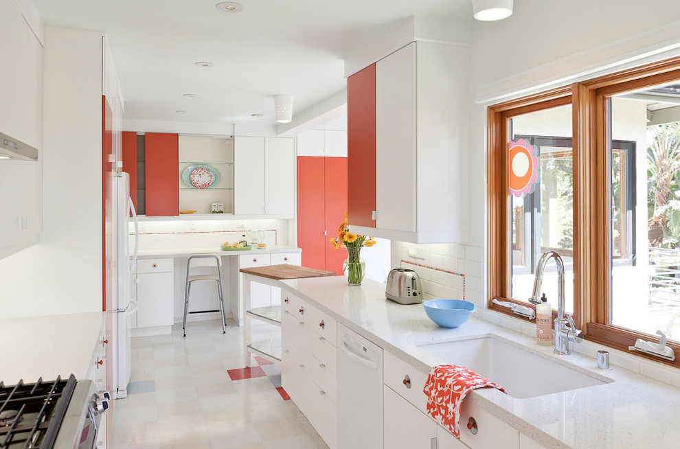 Small minimalist l-shaped linoleum floor and multicolored floor eat-in kitchen photo in Portland with subway tile backsplash, white backsplash, an undermount sink, flat-panel cabinets, white cabinets, white appliances and quartz countertops