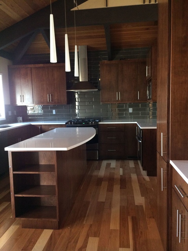 Inspiration for a mid-sized mid-century modern u-shaped light wood floor eat-in kitchen remodel in Seattle with an undermount sink, flat-panel cabinets, brown cabinets, quartzite countertops, gray backsplash, porcelain backsplash, stainless steel appliances and an island