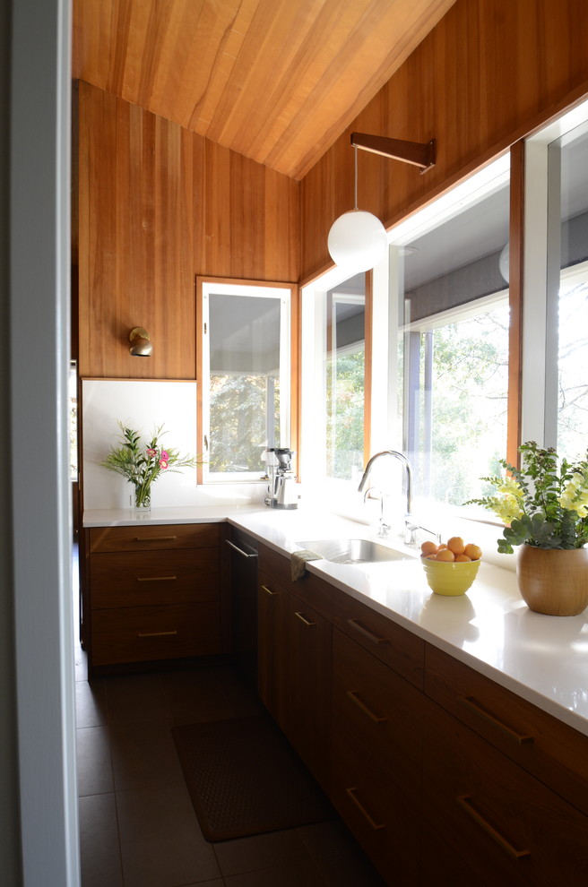 Photo of a medium sized midcentury l-shaped open plan kitchen in Portland with a submerged sink, flat-panel cabinets, medium wood cabinets, engineered stone countertops, white splashback, stainless steel appliances, porcelain flooring, an island and grey floors.