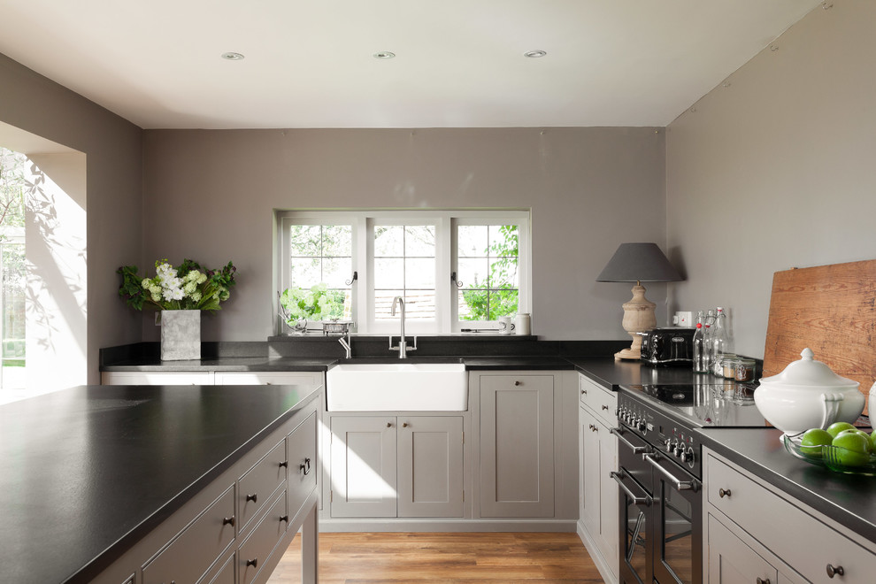 Landhausstil Küche mit Landhausspüle, grauen Schränken und Kücheninsel in Gloucestershire