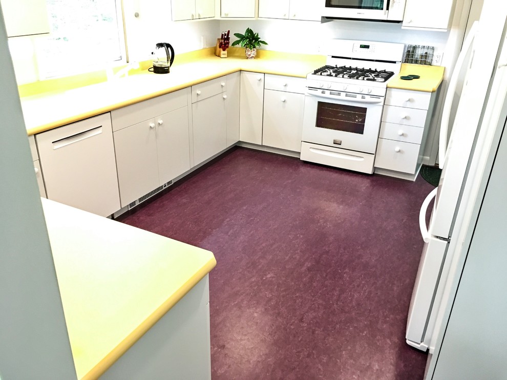 Design ideas for a medium sized midcentury u-shaped enclosed kitchen in New York with a submerged sink, flat-panel cabinets, white cabinets, laminate countertops, white splashback, white appliances, lino flooring and purple floors.