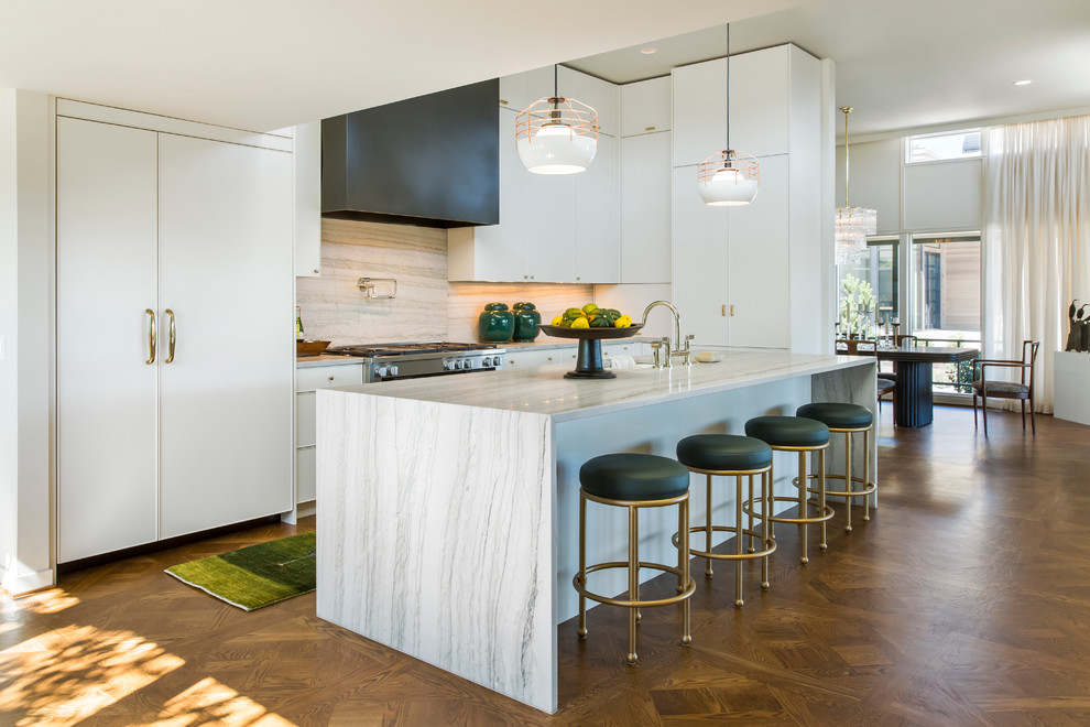 Inspiration for a midcentury galley kitchen in Portland with a submerged sink, flat-panel cabinets, white cabinets, white splashback, integrated appliances, dark hardwood flooring and an island.