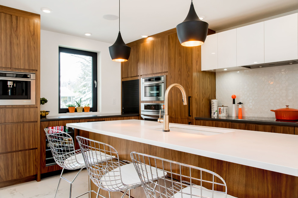 Example of a large 1950s l-shaped porcelain tile eat-in kitchen design in Other with an undermount sink, flat-panel cabinets, medium tone wood cabinets, quartzite countertops, white backsplash, ceramic backsplash, stainless steel appliances and an island
