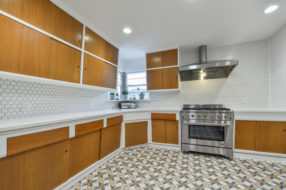 Midcentury kitchen in Dallas with flat-panel cabinets, medium wood cabinets, white splashback, ceramic splashback, stainless steel appliances, no island and white worktops.