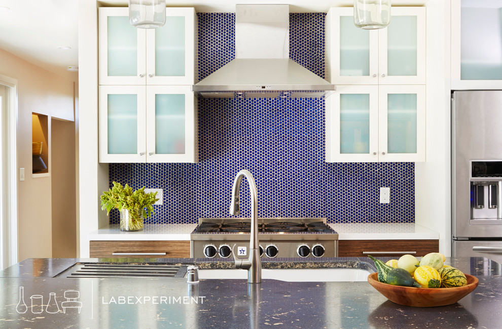 Inspiration for a large 1960s single-wall eat-in kitchen remodel in San Francisco with an undermount sink, glass-front cabinets, white cabinets, quartz countertops, blue backsplash, ceramic backsplash, stainless steel appliances and an island