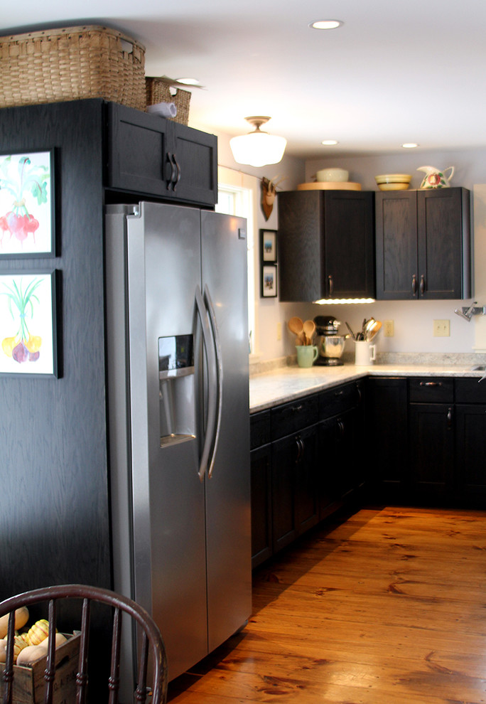 This is an example of a small modern u-shaped kitchen/diner in Burlington with a double-bowl sink, shaker cabinets, black cabinets, laminate countertops, grey splashback, stainless steel appliances, light hardwood flooring and a breakfast bar.