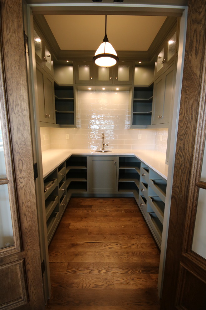 Inspiration for a classic kitchen pantry in Orange County with a submerged sink, open cabinets, green cabinets, engineered stone countertops, white splashback and dark hardwood flooring.