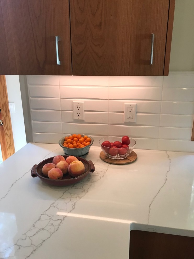 Photo of a large midcentury u-shaped kitchen in Other with a submerged sink, flat-panel cabinets, medium wood cabinets, engineered stone countertops, white splashback, cement tile splashback, porcelain flooring, grey floors and white worktops.