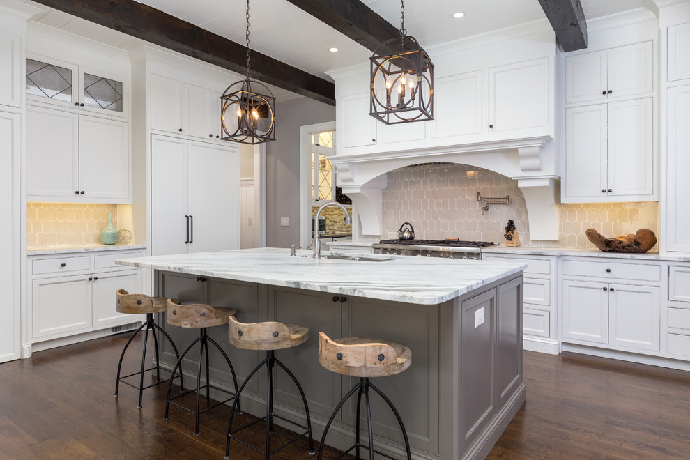 Design ideas for a large classic l-shaped open plan kitchen in Atlanta with a submerged sink, shaker cabinets, white cabinets, beige splashback, integrated appliances, dark hardwood flooring, an island, brown floors, marble worktops and porcelain splashback.
