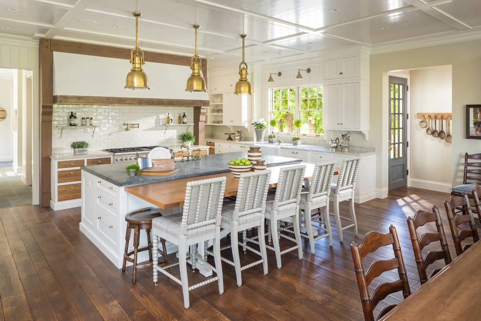 Example of a country l-shaped dark wood floor eat-in kitchen design in Salt Lake City with a farmhouse sink, shaker cabinets, white cabinets, stainless steel appliances and an island