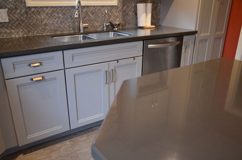 Inspiration for a medium sized eclectic l-shaped enclosed kitchen in Toronto with a submerged sink, recessed-panel cabinets, grey cabinets, quartz worktops, grey splashback, stainless steel appliances, vinyl flooring and an island.