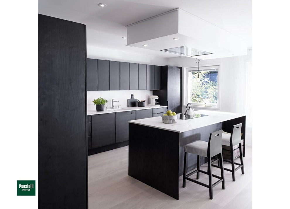 Photo of a large scandinavian l-shaped kitchen in Cheshire with an integrated sink, flat-panel cabinets, black cabinets, white splashback, stainless steel appliances, laminate floors, an island and white worktops.