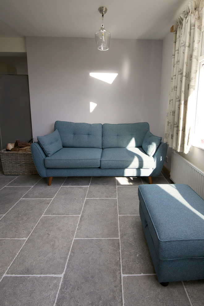 Photo of a medium sized contemporary kitchen in Other with limestone flooring and an island.