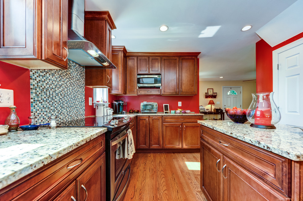 Inspiration for a timeless u-shaped open concept kitchen remodel with an undermount sink, recessed-panel cabinets, medium tone wood cabinets, granite countertops, multicolored backsplash, mosaic tile backsplash and stainless steel appliances