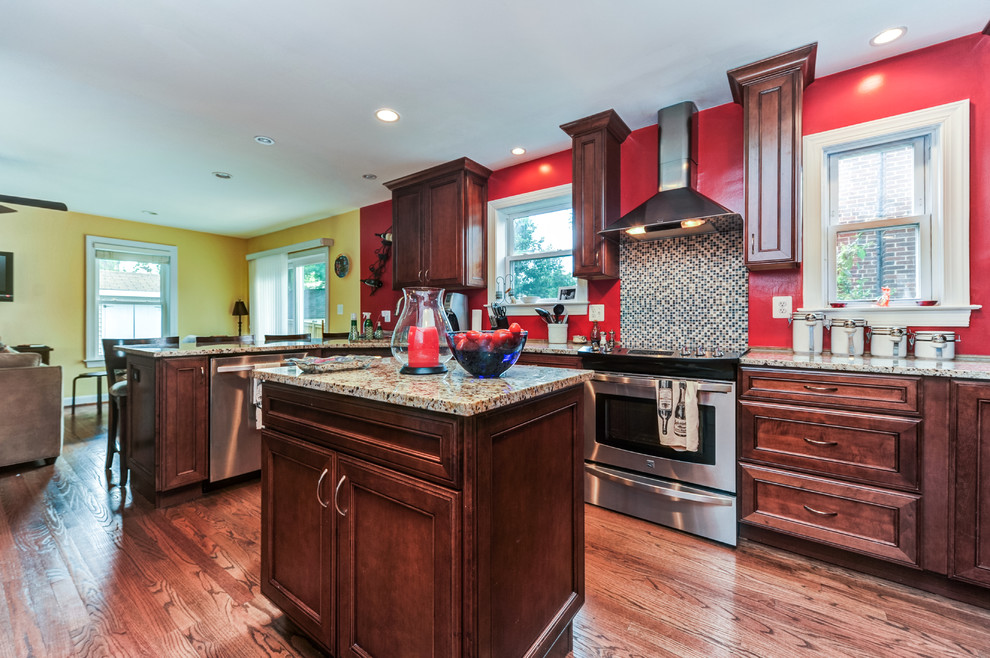 Inspiration for a timeless u-shaped open concept kitchen remodel with an undermount sink, recessed-panel cabinets, medium tone wood cabinets, granite countertops, multicolored backsplash, mosaic tile backsplash and stainless steel appliances