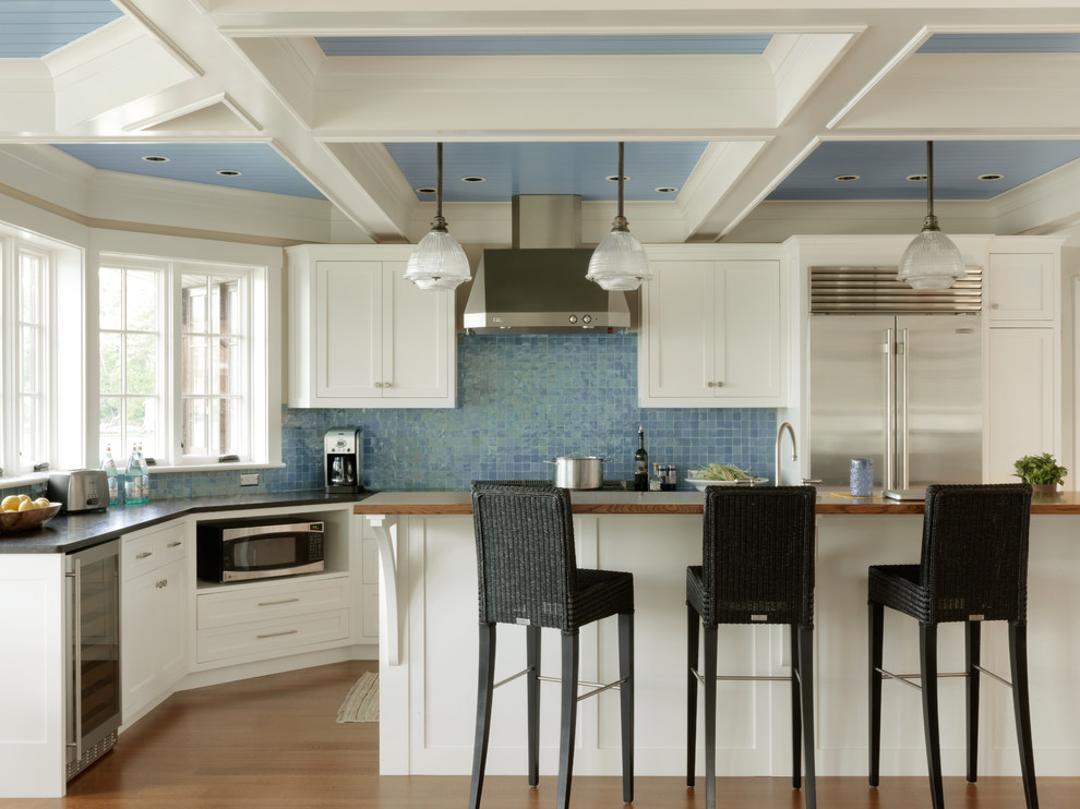 Beach style medium tone wood floor kitchen photo in Burlington with shaker cabinets, white cabinets, blue backsplash, stainless steel appliances and an island