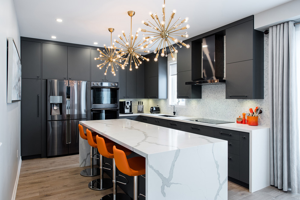 Design ideas for a medium sized contemporary l-shaped enclosed kitchen in Toronto with a submerged sink, flat-panel cabinets, grey cabinets, engineered stone countertops, white splashback, marble splashback, black appliances, light hardwood flooring, an island and beige floors.