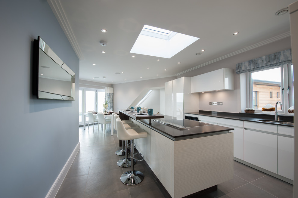 Photo of a contemporary kitchen in London with porcelain flooring and grey floors.