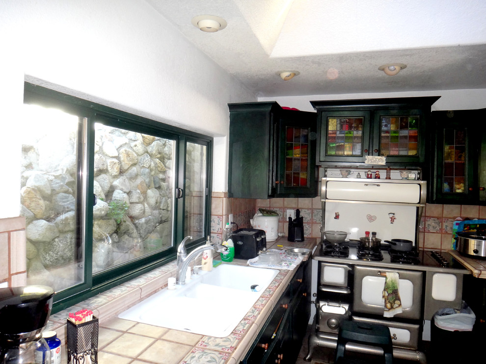 Wohnküche mit Triple-Waschtisch, grünen Schränken, Arbeitsplatte aus Fliesen und weißen Elektrogeräten in Los Angeles