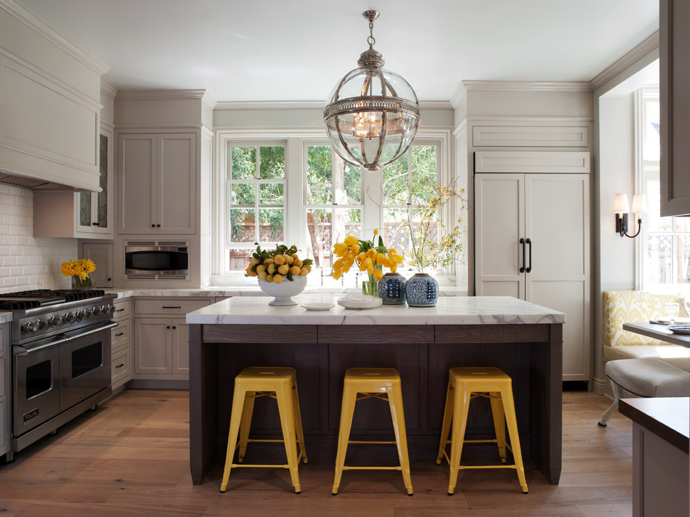 Kitchen - traditional l-shaped kitchen idea in San Francisco with subway tile backsplash, recessed-panel cabinets, gray cabinets, marble countertops, white backsplash and paneled appliances