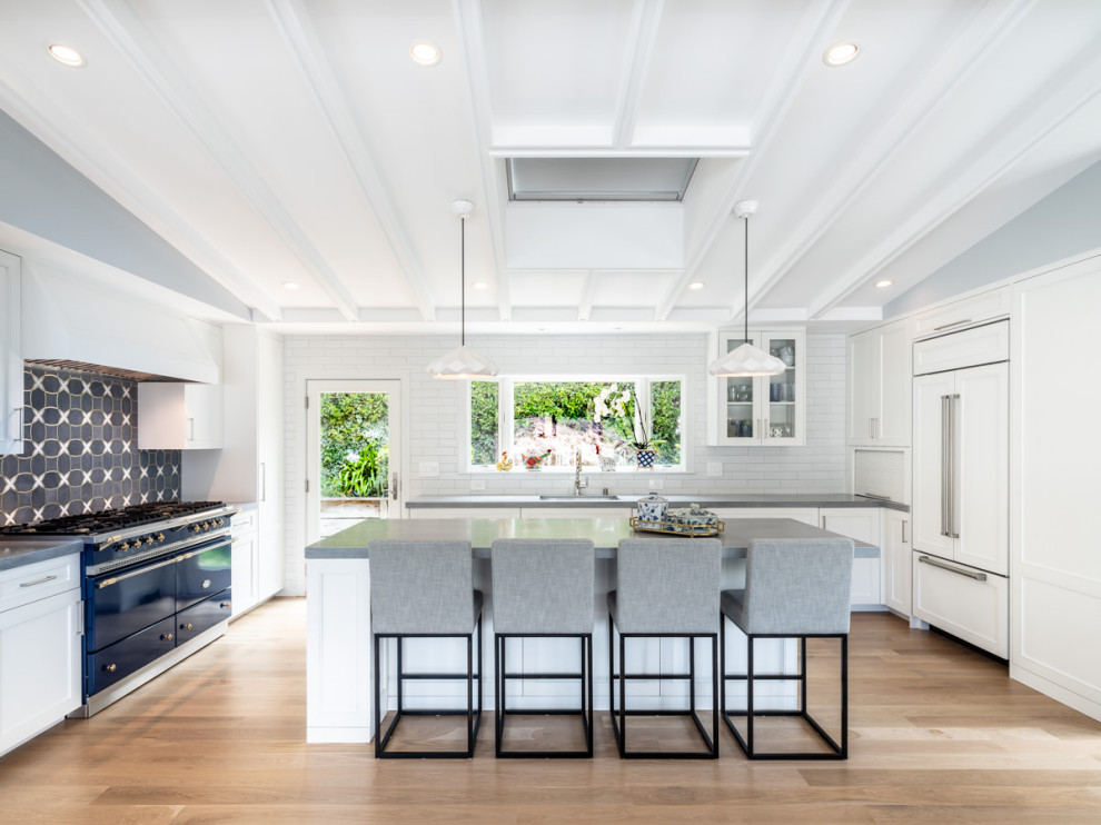 Design ideas for a large contemporary u-shaped kitchen in Sacramento with a submerged sink, white cabinets, white splashback, metro tiled splashback, coloured appliances, medium hardwood flooring, an island, grey worktops and a coffered ceiling.