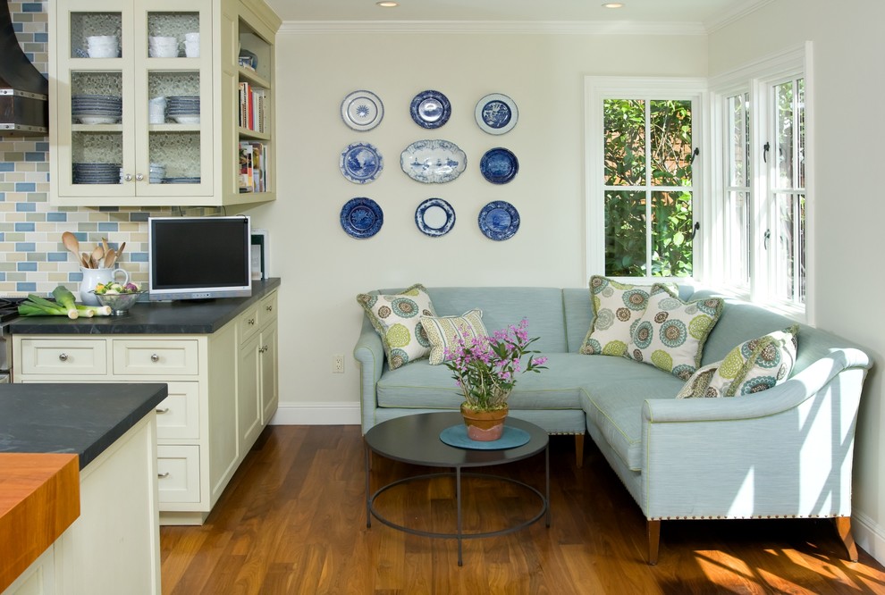 Inspiration for a timeless l-shaped medium tone wood floor and brown floor eat-in kitchen remodel in San Francisco with an undermount sink, recessed-panel cabinets, white cabinets, multicolored backsplash, subway tile backsplash, soapstone countertops, an island and stainless steel appliances