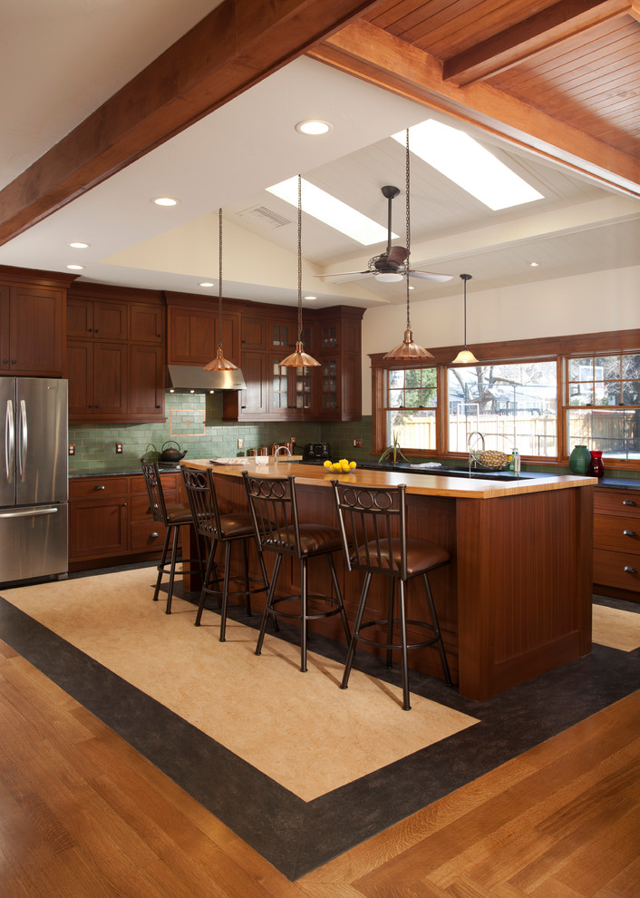 Inspiration for a large craftsman l-shaped eat-in kitchen remodel in Salt Lake City with an undermount sink, shaker cabinets, medium tone wood cabinets, granite countertops, green backsplash, ceramic backsplash, stainless steel appliances and an island