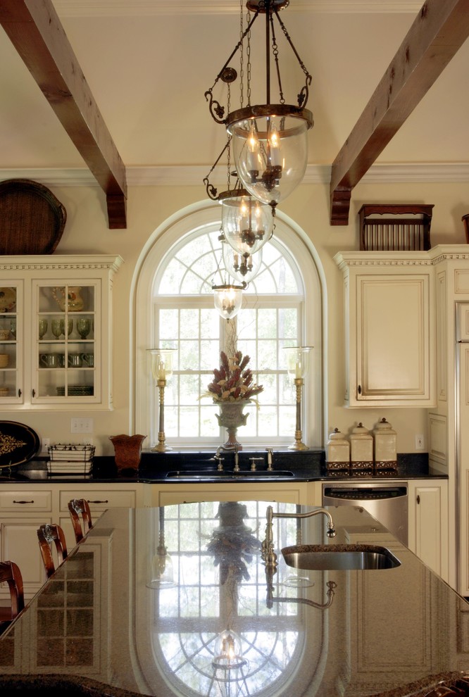Example of a large classic l-shaped dark wood floor eat-in kitchen design in Charleston with an undermount sink, louvered cabinets, white cabinets, granite countertops, white backsplash, subway tile backsplash, stainless steel appliances and an island