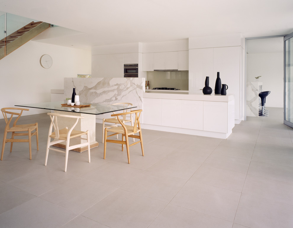 Photo of a contemporary galley kitchen/diner in Melbourne with flat-panel cabinets, white cabinets and grey splashback.