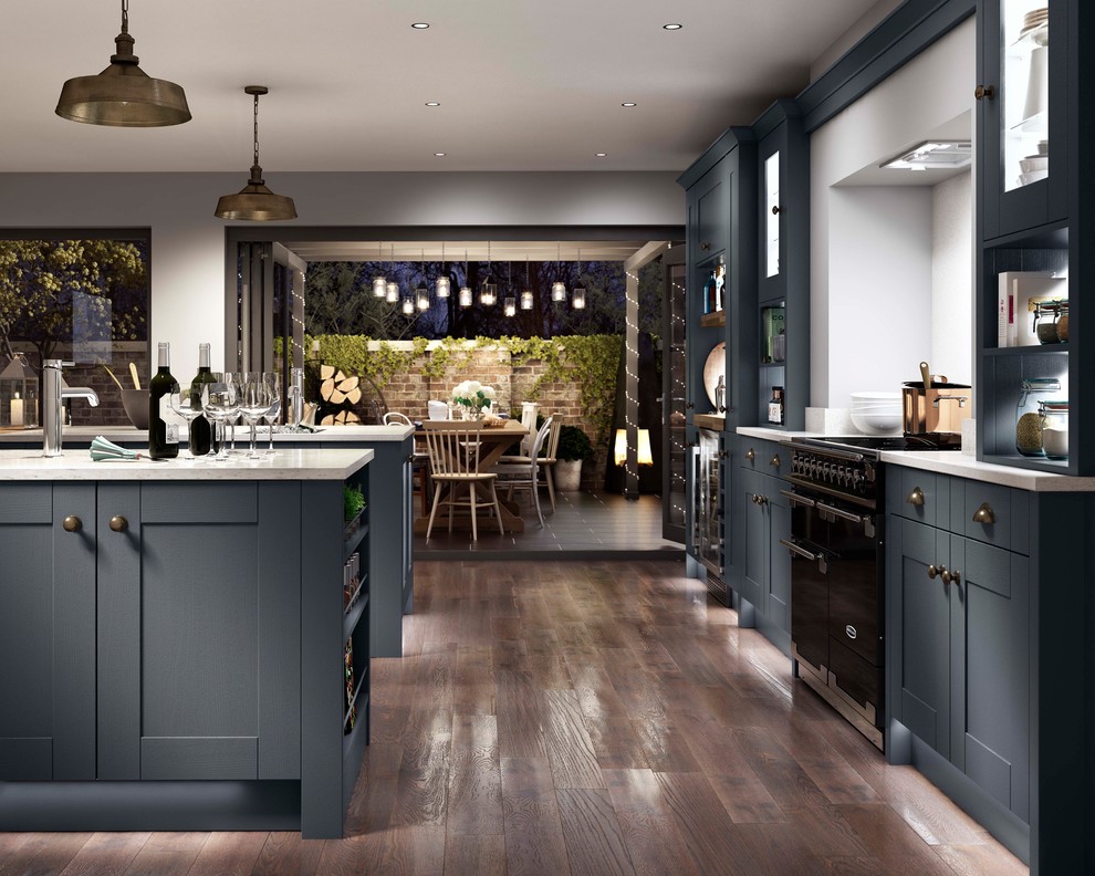 This is an example of a large country open plan kitchen in Other with multiple islands, blue cabinets, quartz worktops, shaker cabinets, white splashback, black appliances, a built-in sink, dark hardwood flooring and brown floors.