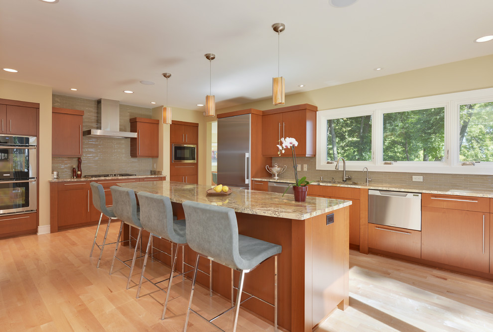 Example of a large trendy u-shaped light wood floor and brown floor eat-in kitchen design in Milwaukee with an undermount sink, flat-panel cabinets, medium tone wood cabinets, beige backsplash, stainless steel appliances, an island, multicolored countertops and matchstick tile backsplash