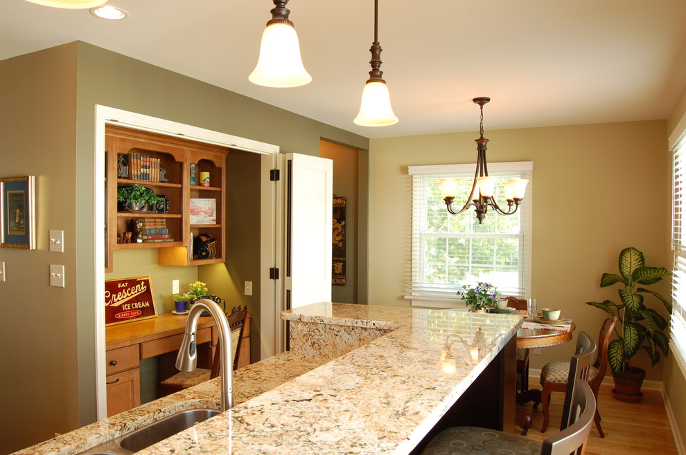 Mid-sized elegant l-shaped light wood floor eat-in kitchen photo in Milwaukee with a double-bowl sink, shaker cabinets, medium tone wood cabinets, granite countertops, beige backsplash, stainless steel appliances and an island