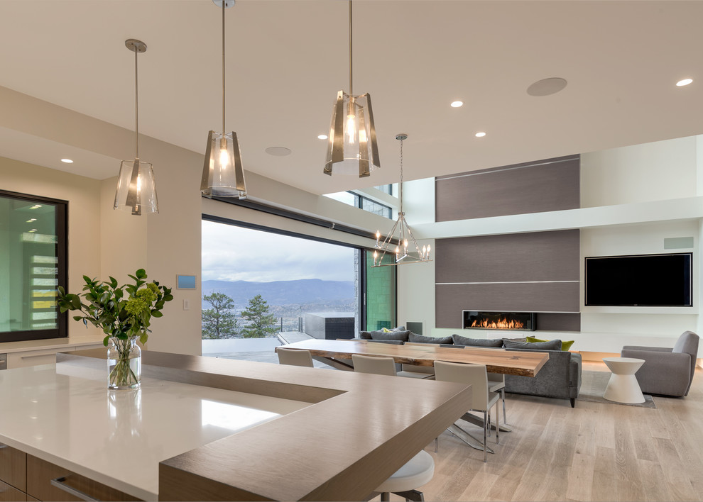 Large minimalist l-shaped light wood floor eat-in kitchen photo in Vancouver with flat-panel cabinets, dark wood cabinets, quartz countertops, white backsplash, subway tile backsplash, stainless steel appliances and an island