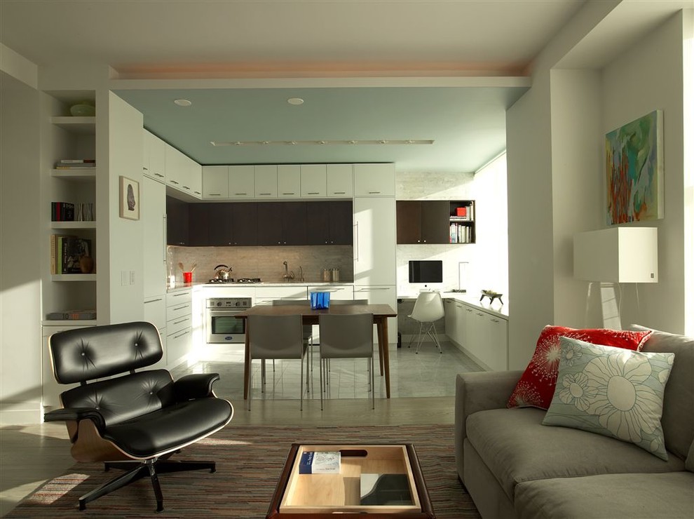 Open concept kitchen - modern l-shaped open concept kitchen idea in New York with stainless steel appliances, flat-panel cabinets, white cabinets, white backsplash and stone tile backsplash