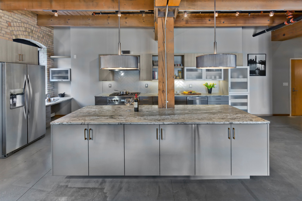 Photo of a large industrial l-shaped kitchen in Minneapolis with a submerged sink, flat-panel cabinets, grey cabinets, grey splashback, stainless steel appliances, an island, grey floors, grey worktops and exposed beams.