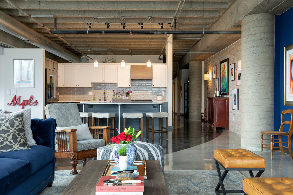 This is an example of an eclectic l-shaped kitchen/diner in Minneapolis with a submerged sink, shaker cabinets, grey cabinets, engineered stone countertops, grey splashback, ceramic splashback, stainless steel appliances, concrete flooring, an island, grey floors and white worktops.
