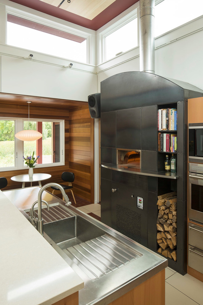 Contemporary kitchen/diner in Minneapolis with stainless steel worktops.