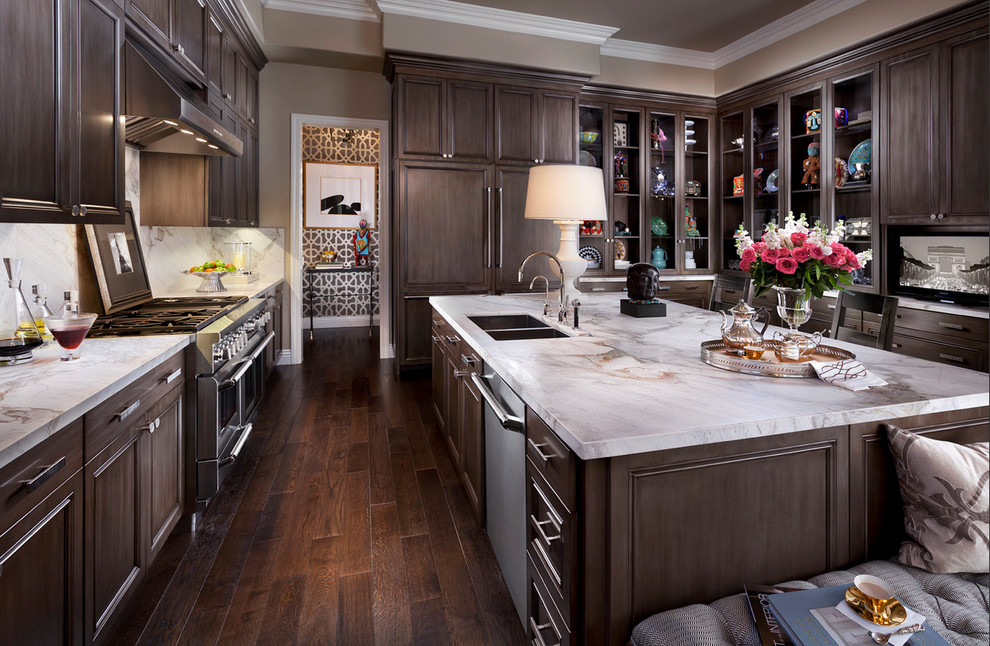 Large transitional u-shaped dark wood floor and brown floor eat-in kitchen photo in Salt Lake City with a double-bowl sink, dark wood cabinets, white backsplash, stainless steel appliances, marble countertops, stone slab backsplash, an island and recessed-panel cabinets